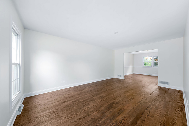 2010 Bilter Road Aurora, IL 60502 - Photo 13 of 47 an empty room with wooden floor and windows