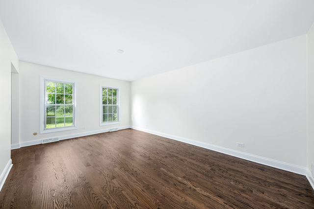 2010 Bilter Road Aurora, IL 60502 - Photo 15 of 47 an empty room with wooden floor and windows