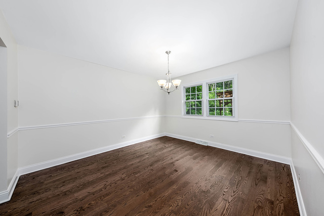 2010 Bilter Road Aurora, IL 60502 - Photo 16 of 47 an empty room with wooden floor and windows