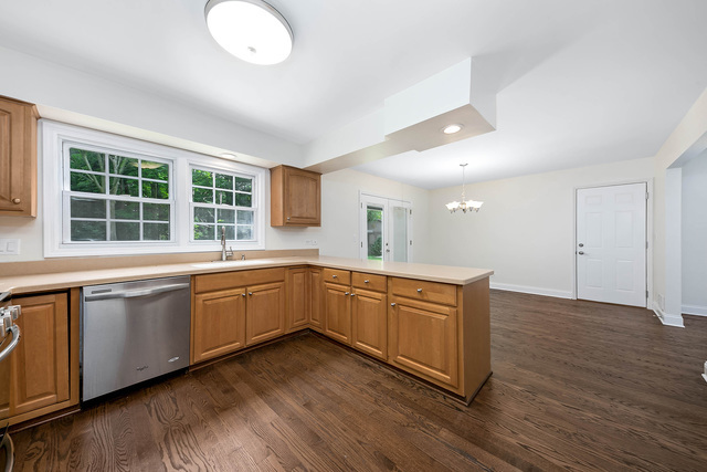 2010 Bilter Road Aurora, IL 60502 - Photo 9 of 47 a kitchen with wooden floors and white cabinets