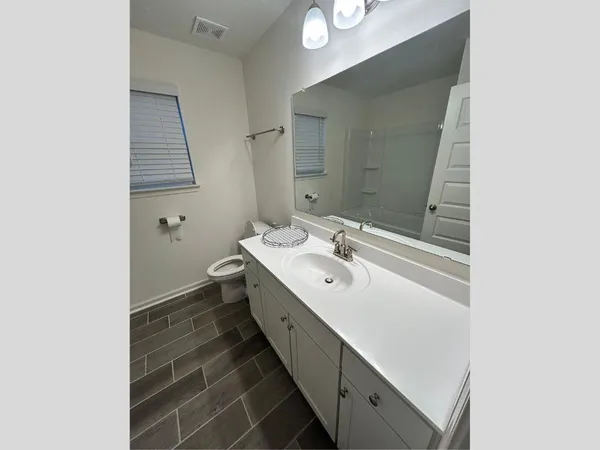 a bathroom with a double vanity sink and mirror