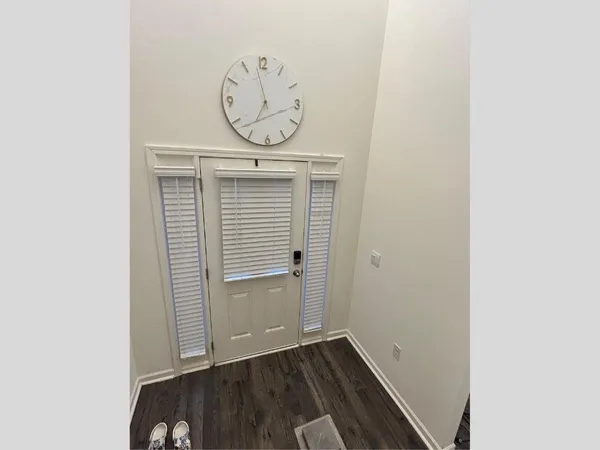 a view of a hallway with wooden floor
