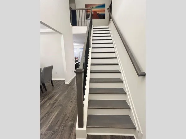 a view of entryway and hall with wooden floor