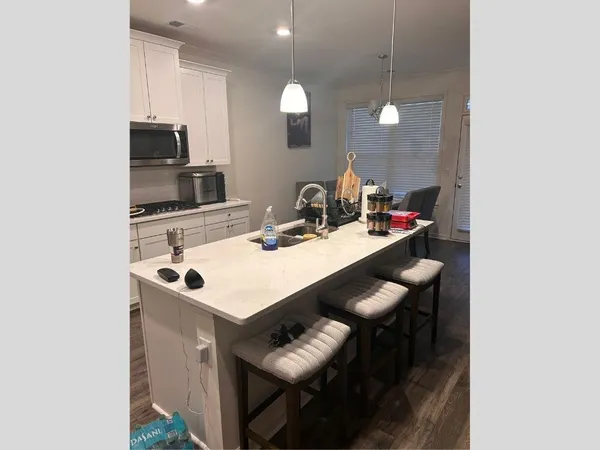 a kitchen with a sink a counter space and appliances
