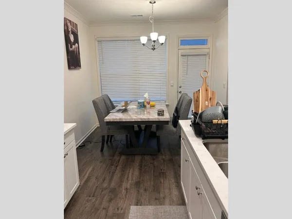 a dining room with furniture and chandelier