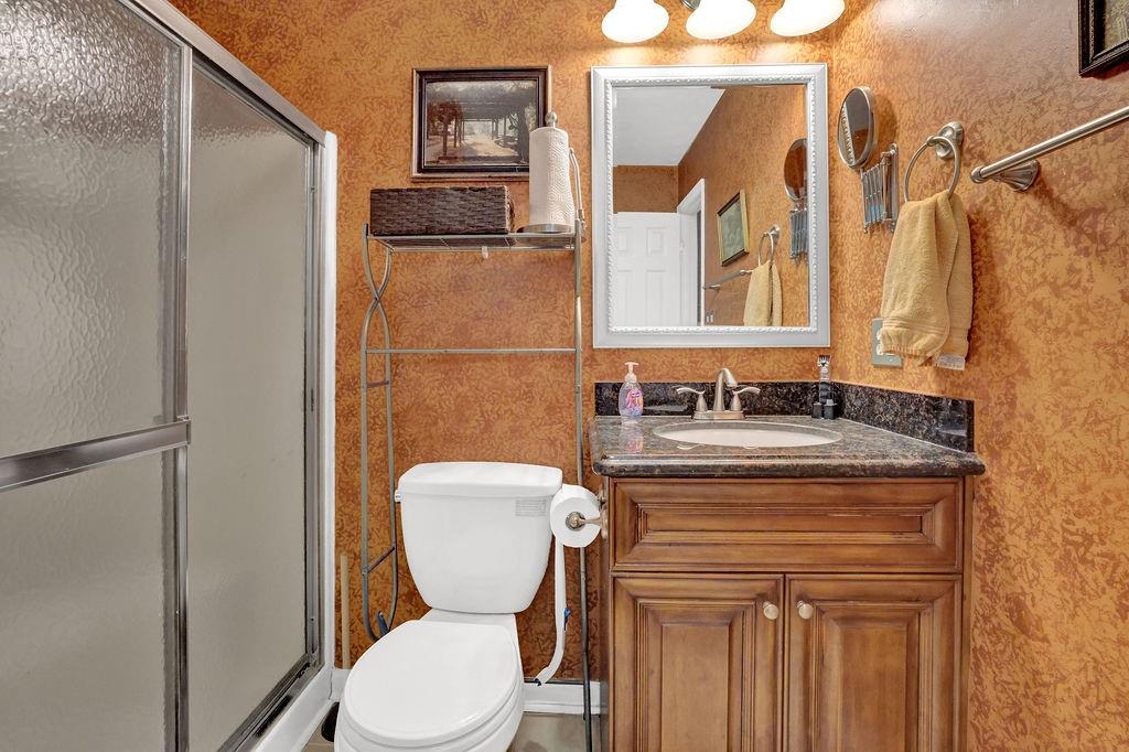 1555 Rock Springs Road Buford, GA 30519 - Photo 20 of 27 a bathroom with a granite countertop toilet sink and mirror