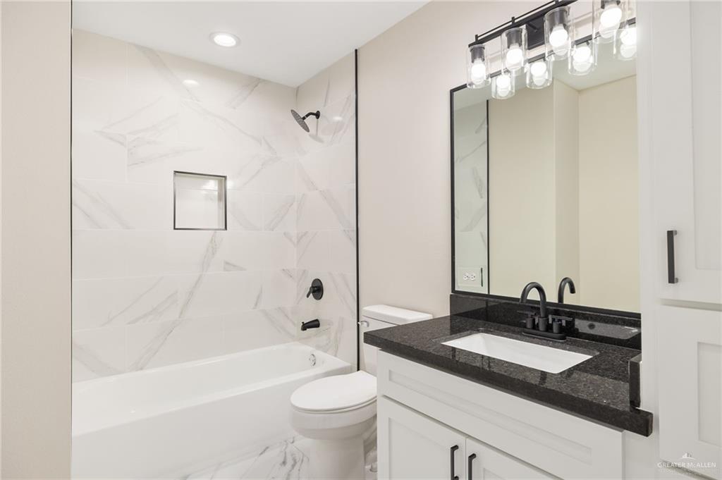 348 Coro Street Donna, TX 78537 - Photo 11 of 17 a bathroom with a sink double vanity granite tub and a mirror