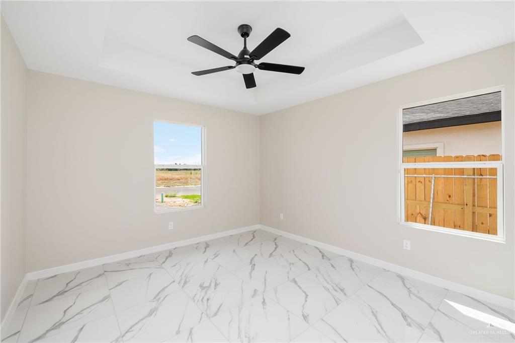 348 Coro Street Donna, TX 78537 - Photo 8 of 17 an empty room with a window and a ceiling fan