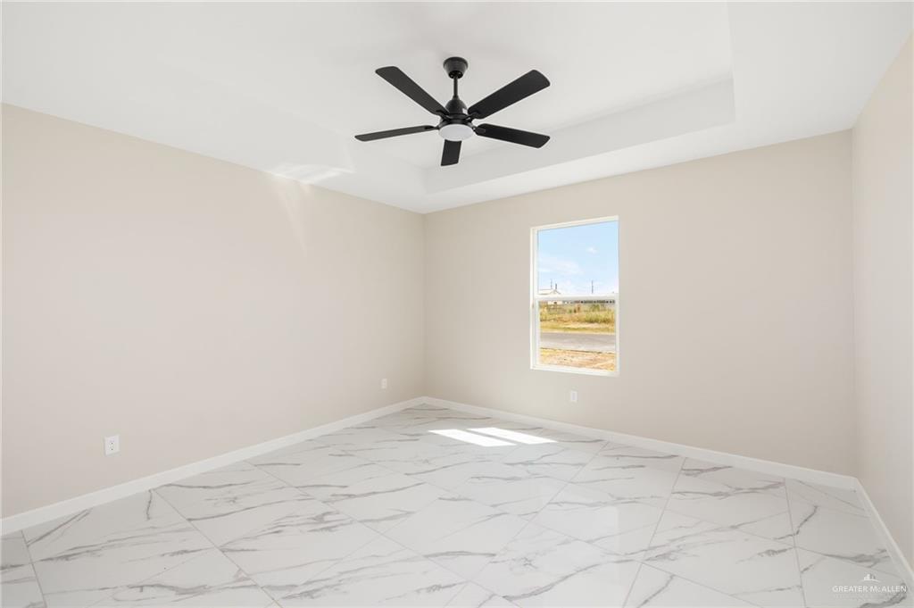 348 Coro Street Donna, TX 78537 - Photo 9 of 17 a view of a big room with windows and ceiling fan