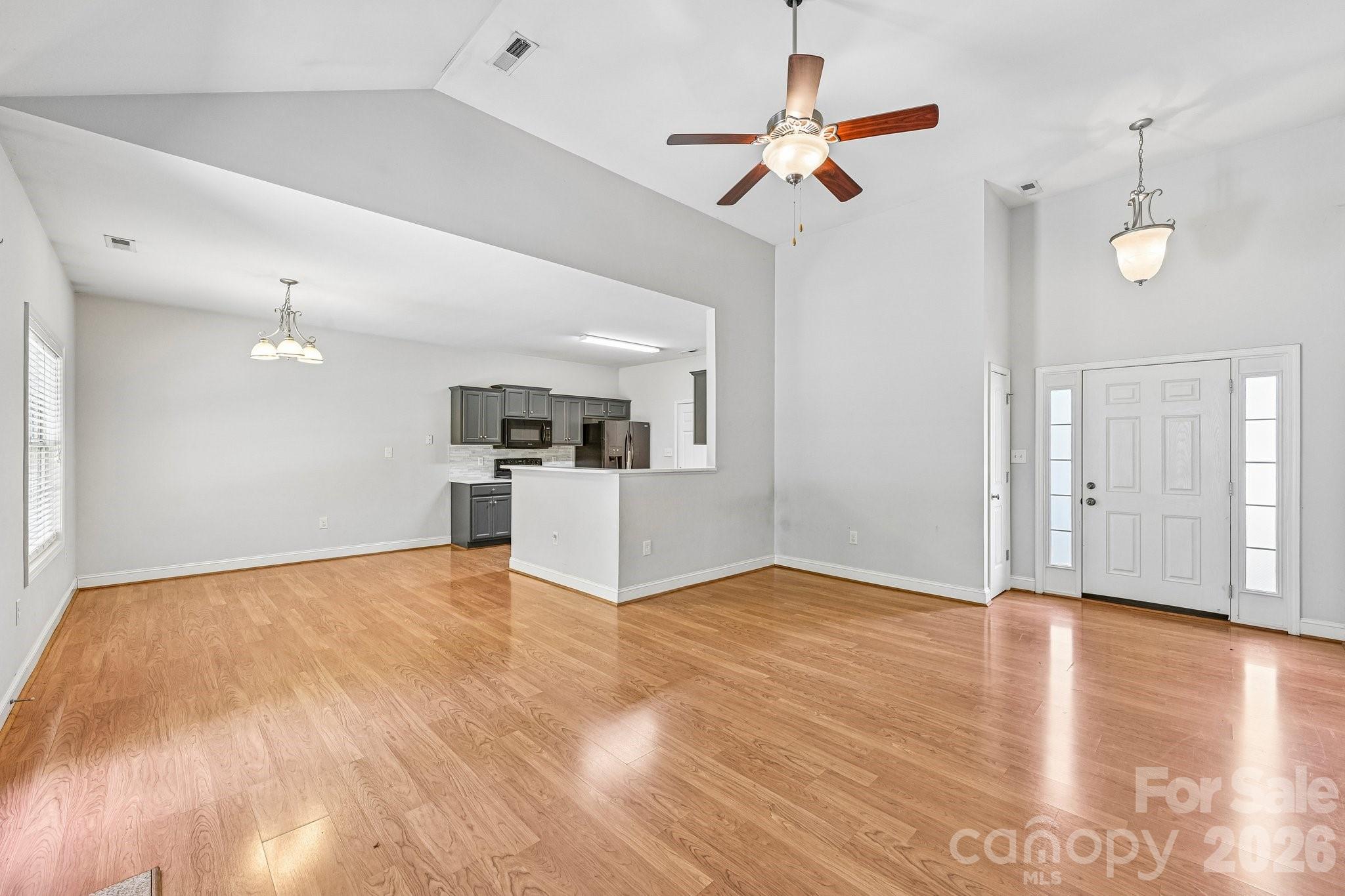 624 Hunley Street Monroe, NC 28112 - Photo 9 of 36 a view of empty room with wooden floor and ceiling fan