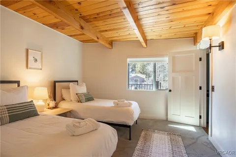 a bedroom with double bed and a window