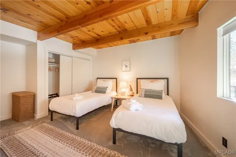 a bedroom with a bed and a night stand