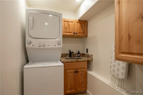 a view of a rooftop deck with couch and chairs