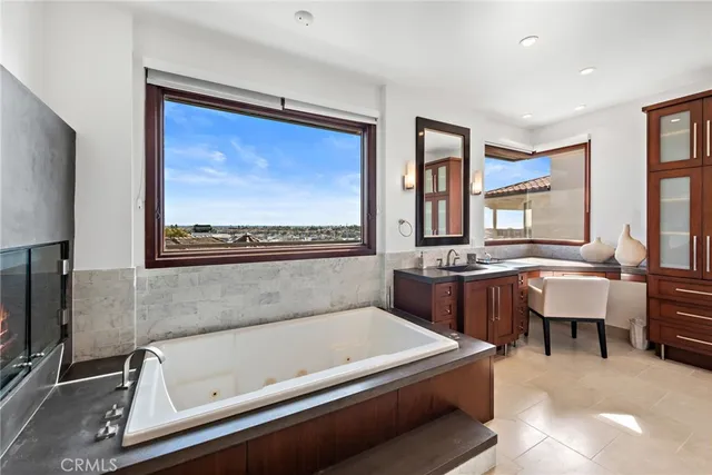 a bath room with a bathtub and a large mirror