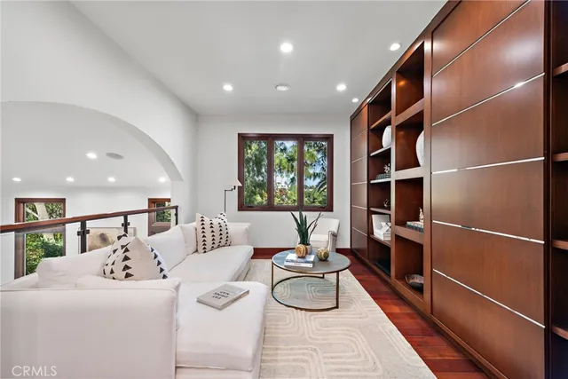 a living room with furniture a window and wooden floor