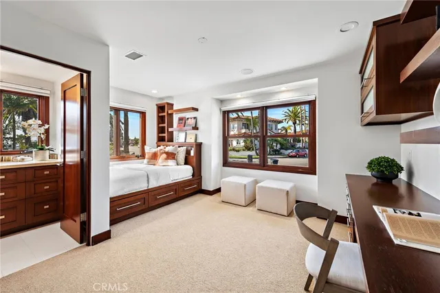 a bedroom with furniture and a large window