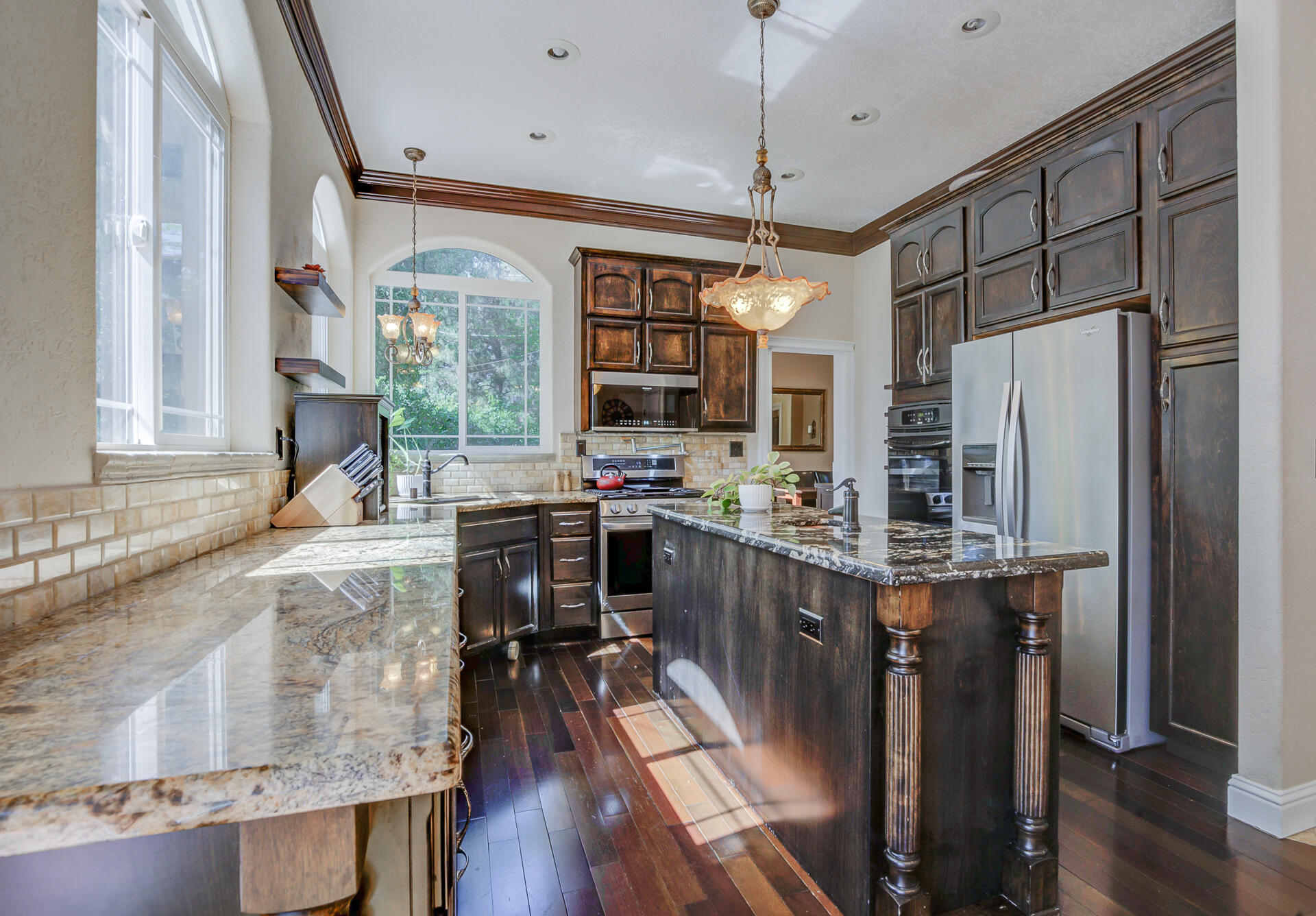 5146 Surrey Drive Redding, CA 96002 - Photo 15 of 57 a kitchen with stainless steel appliances granite countertop a refrigerator a oven a stove and a wooden floors