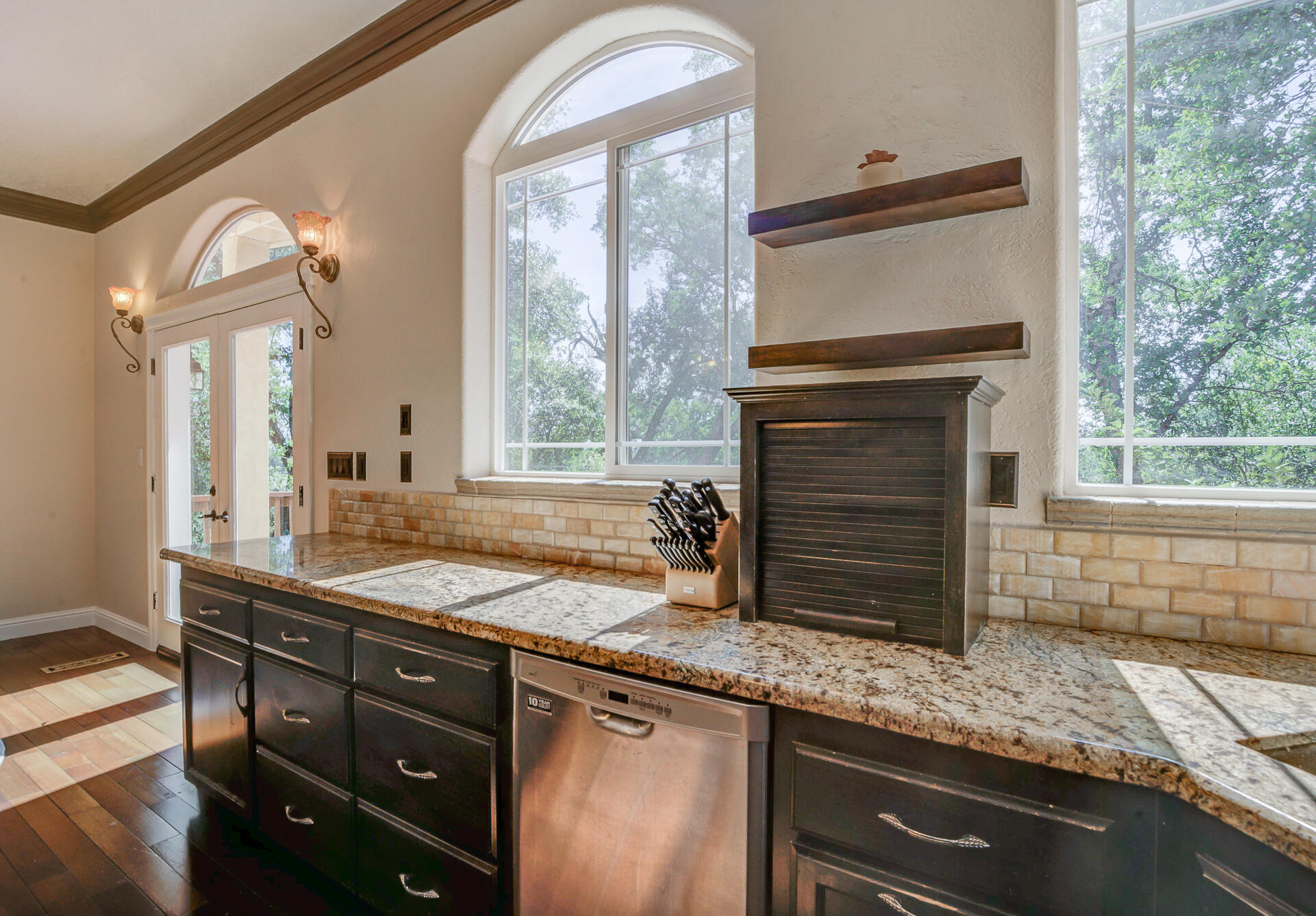 5146 Surrey Drive Redding, CA 96002 - Photo 21 of 57 a kitchen with granite countertop a stove a sink and a wooden cabinets