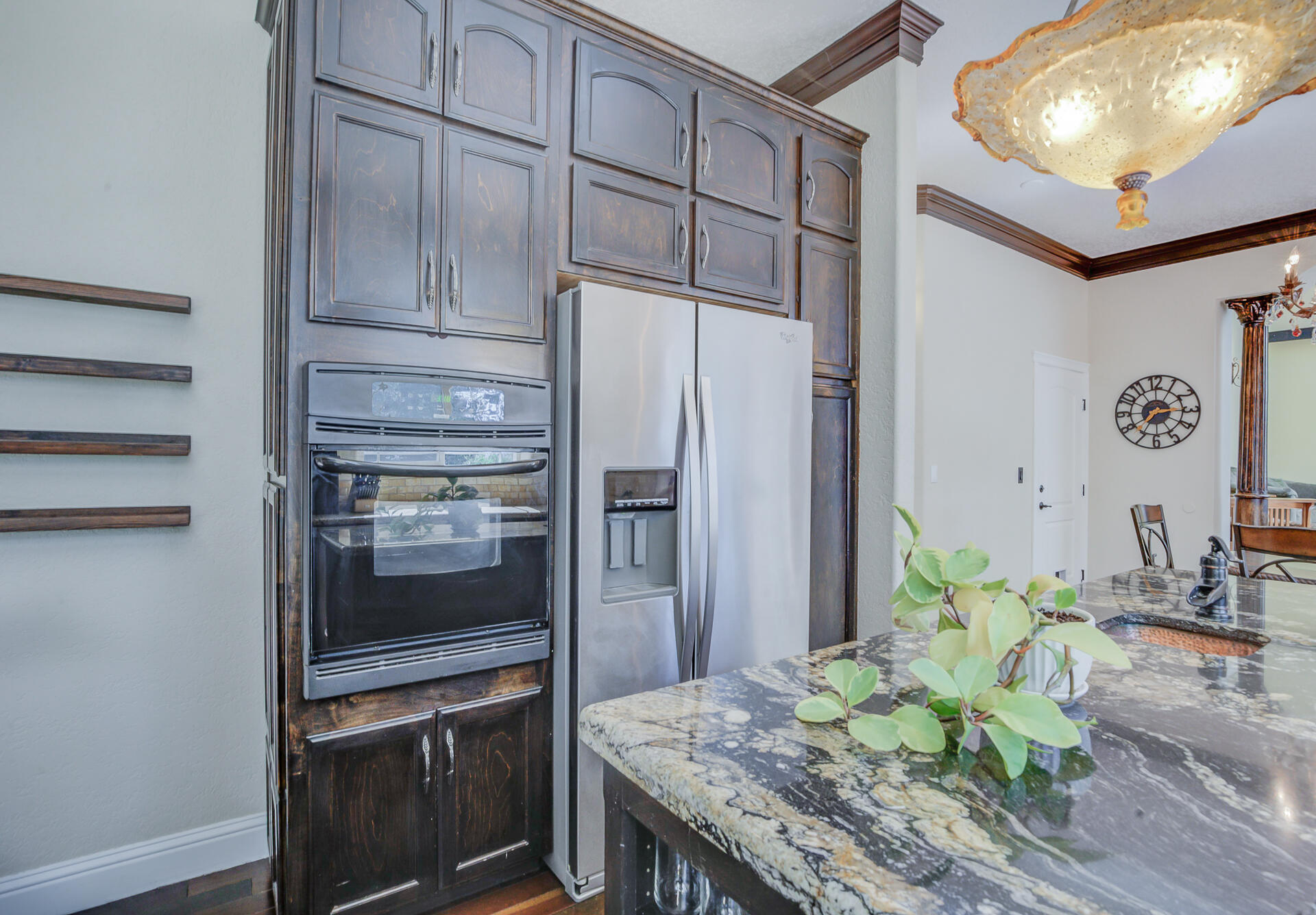 5146 Surrey Drive Redding, CA 96002 - Photo 22 of 57 a kitchen with granite countertop a refrigerator and wooden floor