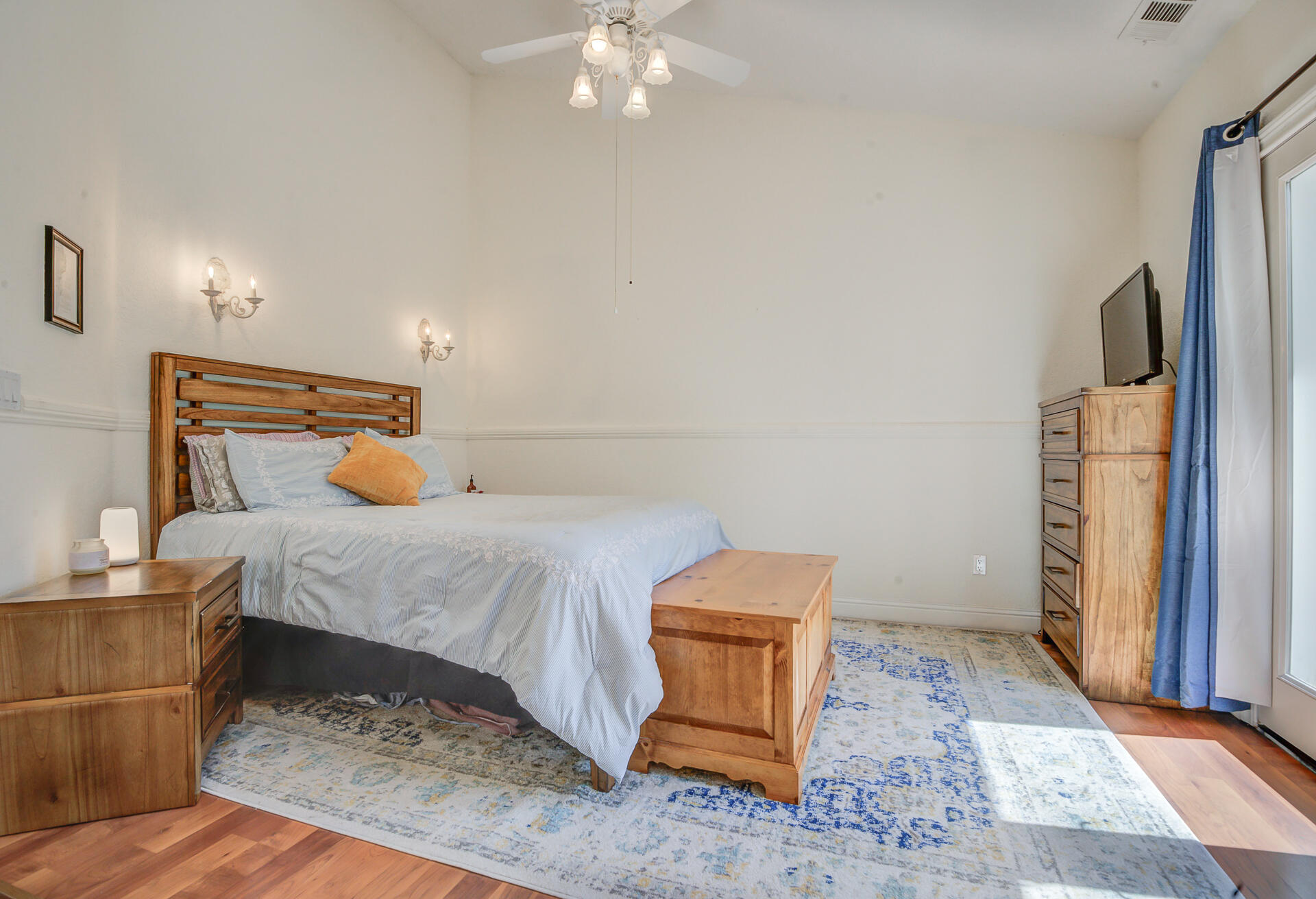 5146 Surrey Drive Redding, CA 96002 - Photo 29 of 57 a bed sitting in a bedroom next to a window and a chandelier