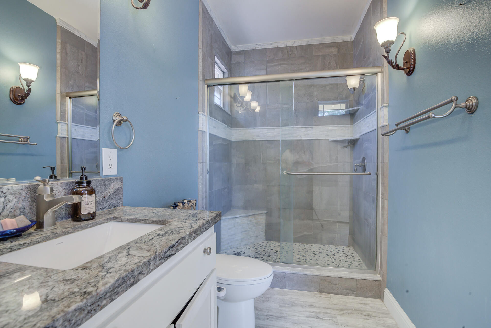 5146 Surrey Drive Redding, CA 96002 - Photo 34 of 57 a bathroom with a granite countertop sink a toilet and shower