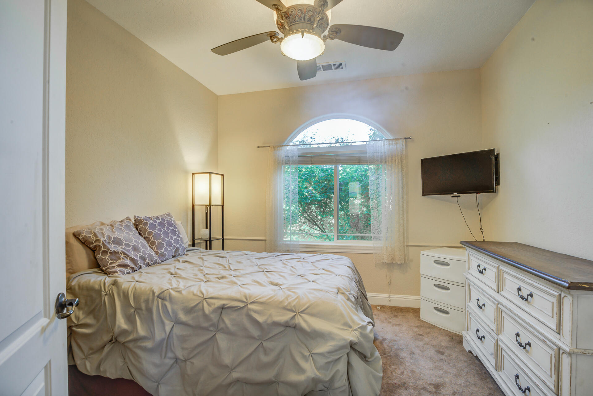 5146 Surrey Drive Redding, CA 96002 - Photo 36 of 57 a bedroom with a bed and a flat tv screen on dresser
