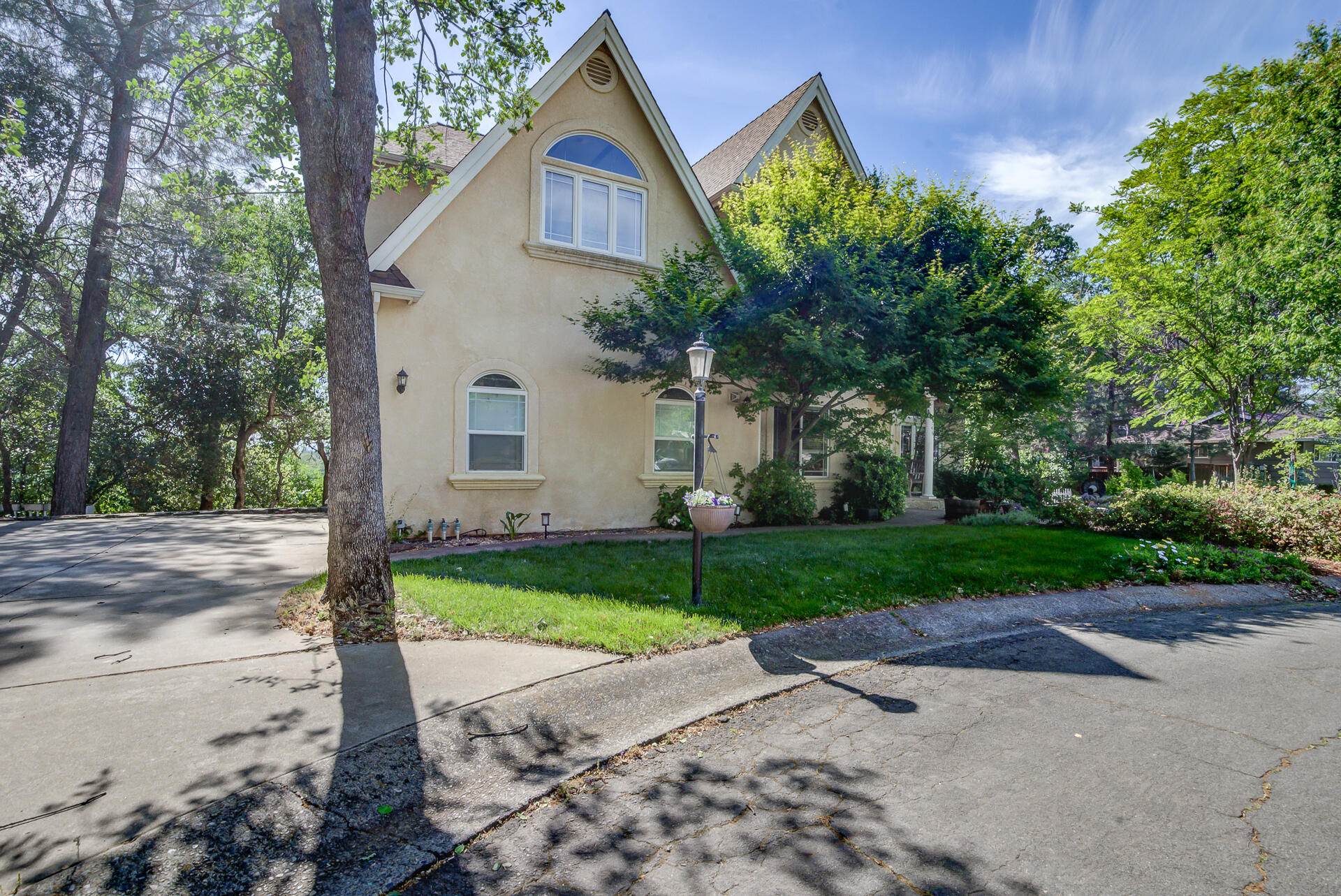 5146 Surrey Drive Redding, CA 96002 - Photo 54 of 57 a front view of a house with a yard and garage