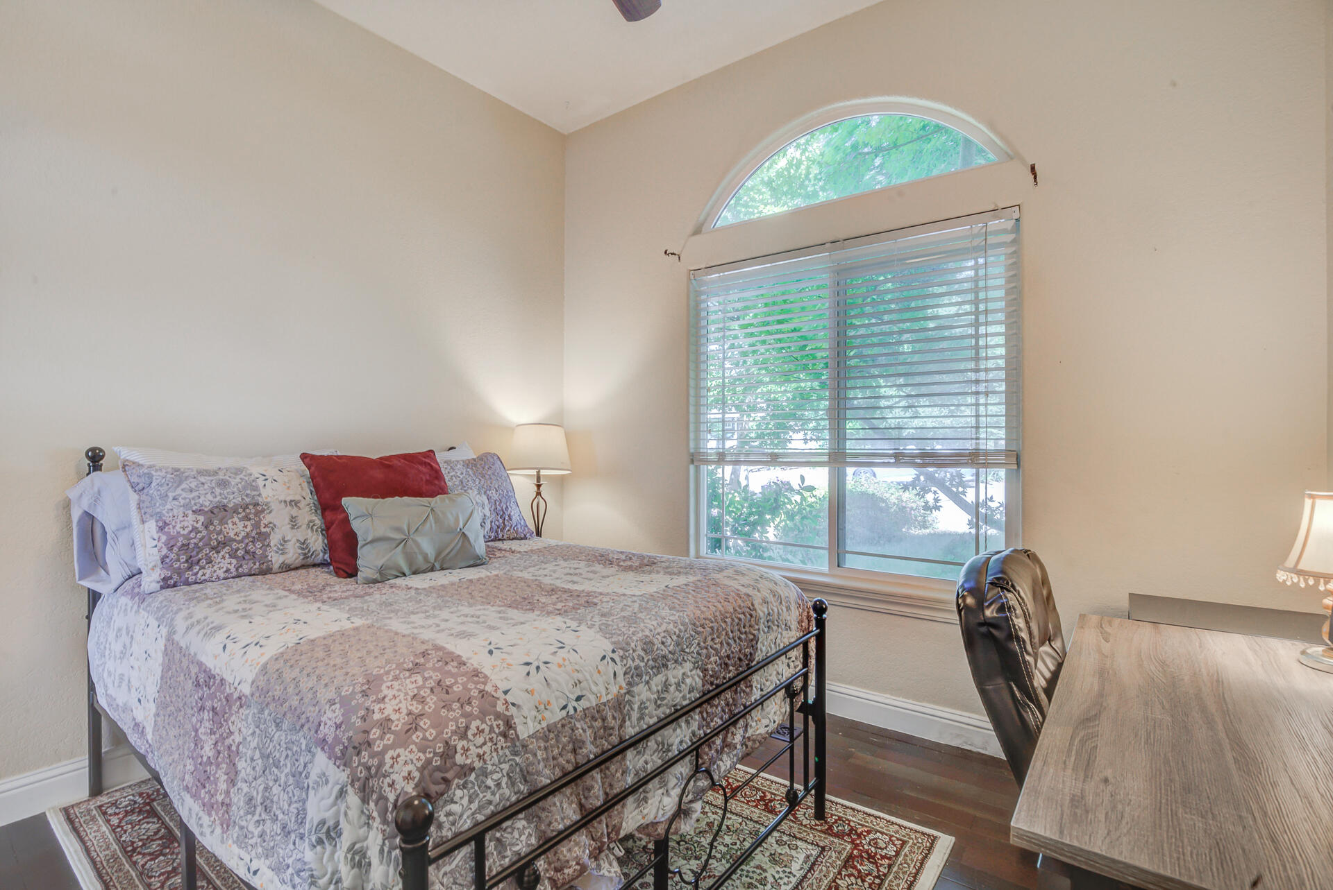 5146 Surrey Drive Redding, CA 96002 - Photo 7 of 57 a bedroom with a bed a table and a large window