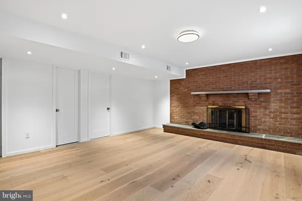 a view of an empty room with a fireplace and a window