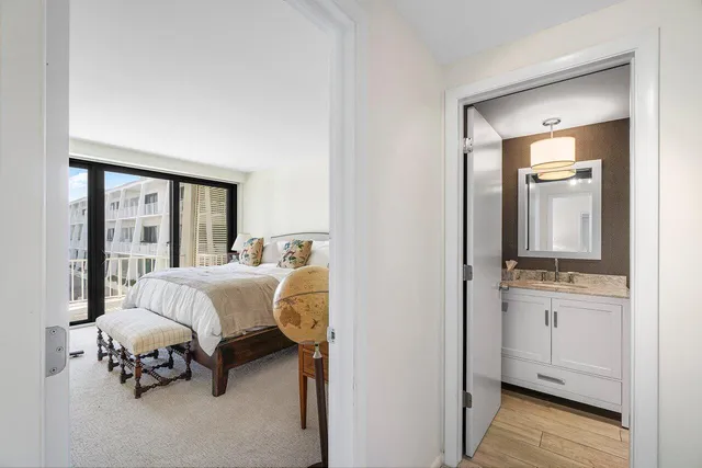 a bedroom with a bed and a night stand with potted plant