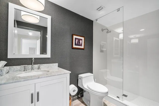 a bathroom with a double vanity sink mirror and shower