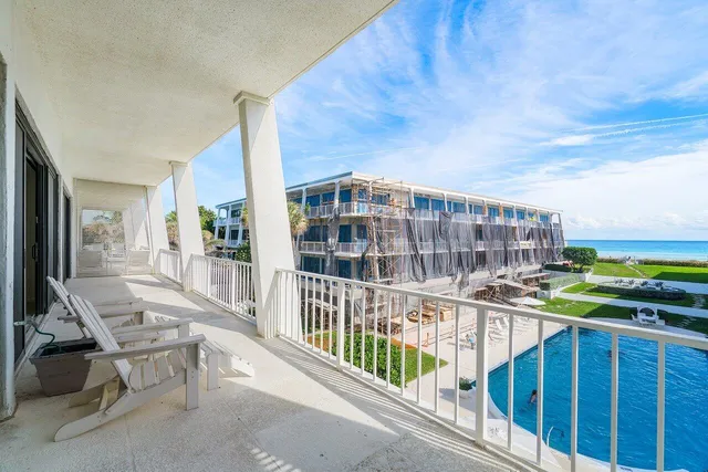 a view of a dining room with furniture and a chandelier