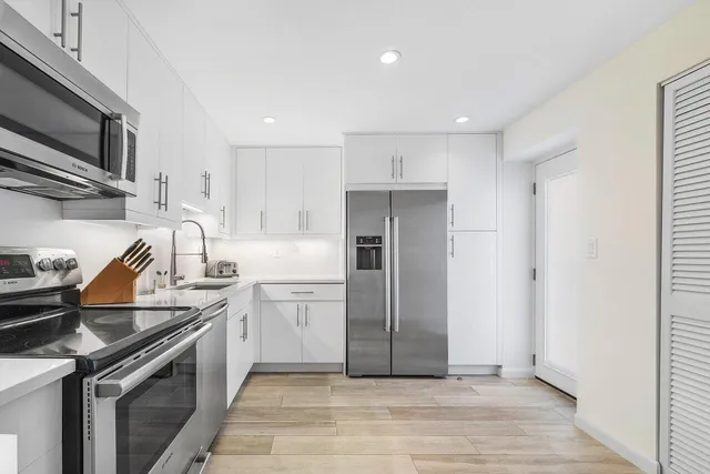 a kitchen with a sink cabinets and stainless steel appliances