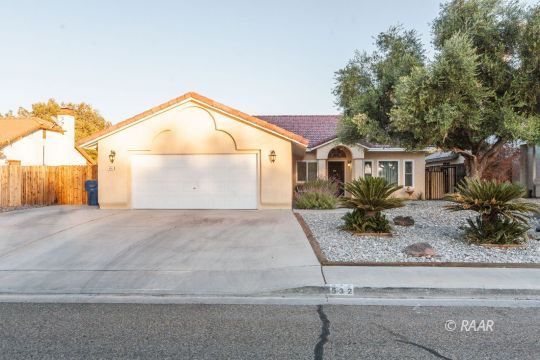 532 Amanda Street Ridgecrest, CA 93555 - Photo 1 of 35 a front view of a house with garage and plants