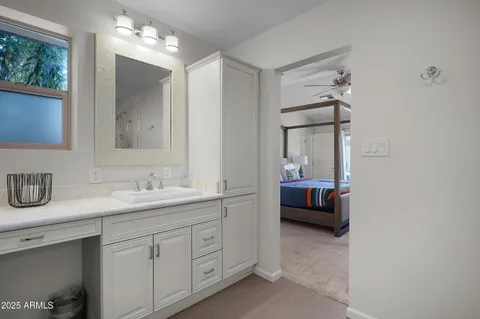 a en suite bathroom with a double vanity sink a mirror and a shower