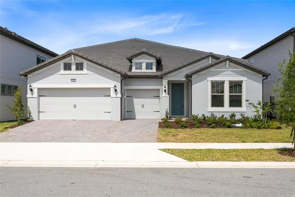 a front view of a house with a yard and garage