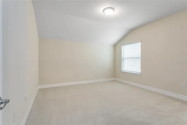 an empty room with a empty space and windows