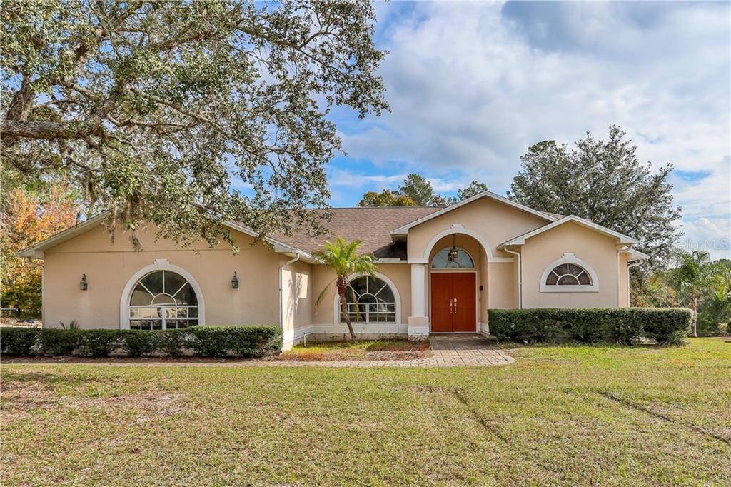 8412 Nightingale Road Weeki Wachee, FL 34613 - Photo 1 of 1 a front view of a house with a yard