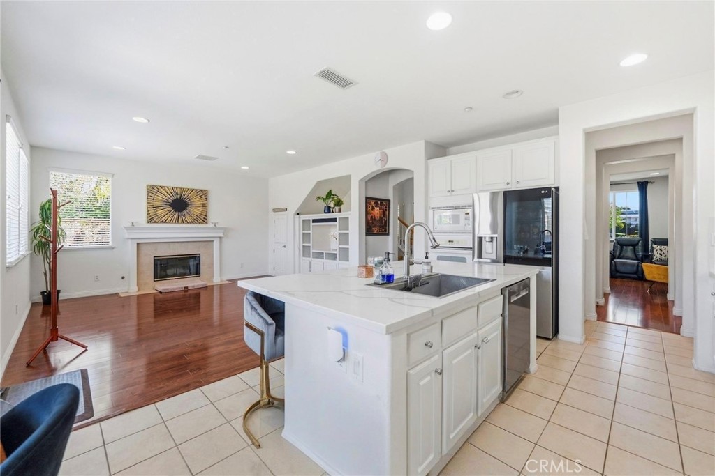 1663 Naranjo Court Redlands, CA 92374 - Photo 13 of 59 a kitchen with white cabinets and sink