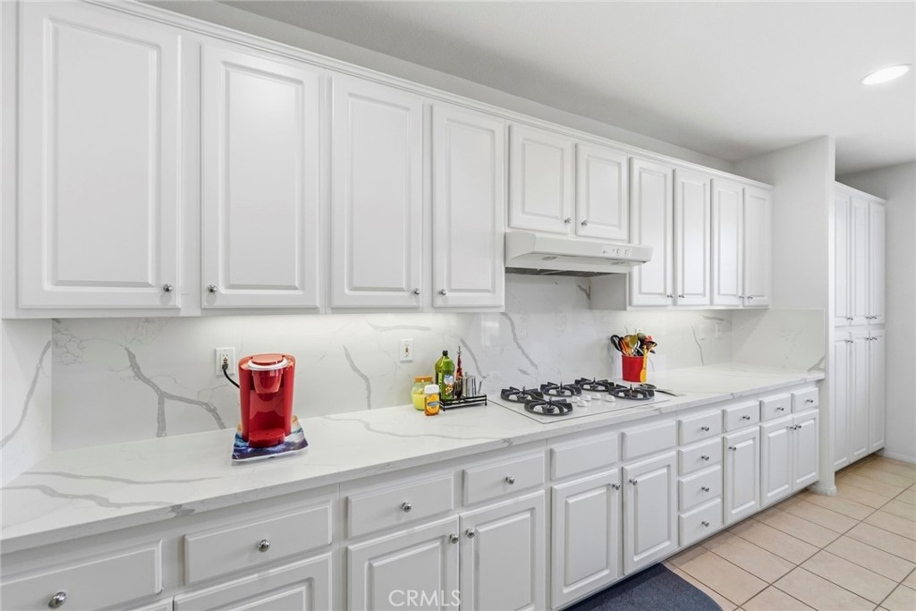1663 Naranjo Court Redlands, CA 92374 - Photo 14 of 59 a kitchen with white cabinets and sink