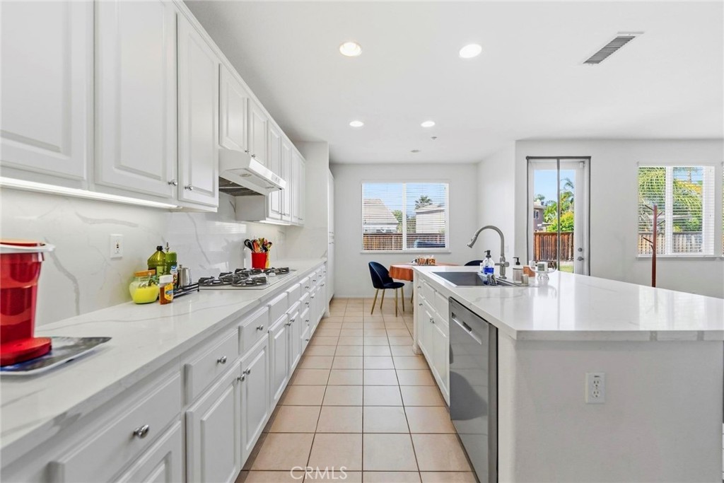 1663 Naranjo Court Redlands, CA 92374 - Photo 15 of 59 a kitchen with kitchen island granite countertop lots of counter top space and windows