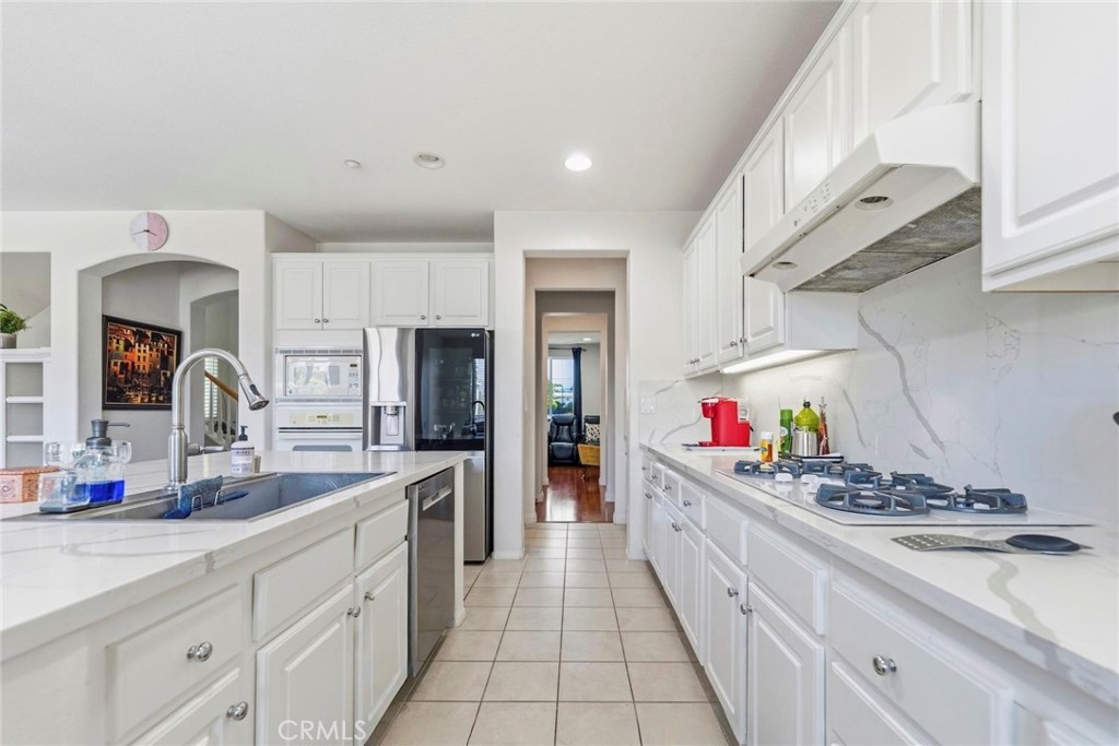 1663 Naranjo Court Redlands, CA 92374 - Photo 17 of 59 a kitchen with stove a sink and cabinets