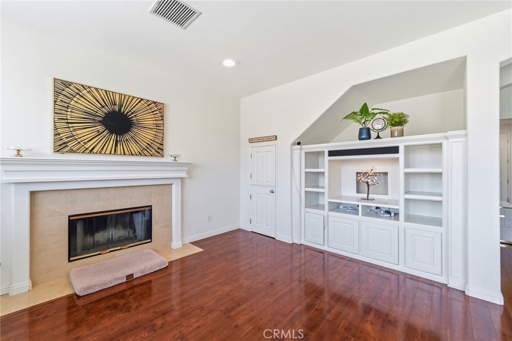 1663 Naranjo Court Redlands, CA 92374 - Photo 18 of 59 a view of a livingroom with wooden floor a fireplace and window
