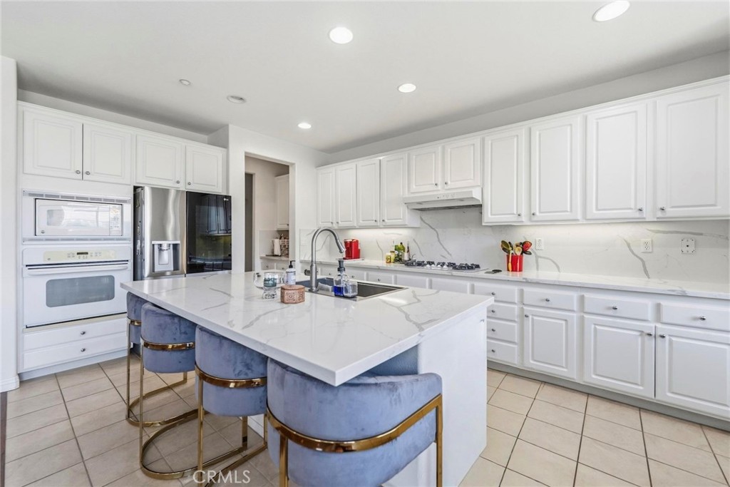 1663 Naranjo Court Redlands, CA 92374 - Photo 20 of 59 a kitchen with granite countertop a sink appliances cabinets and counter space