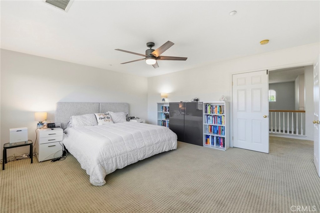1663 Naranjo Court Redlands, CA 92374 - Photo 27 of 59 a bedroom with bed and a chandelier