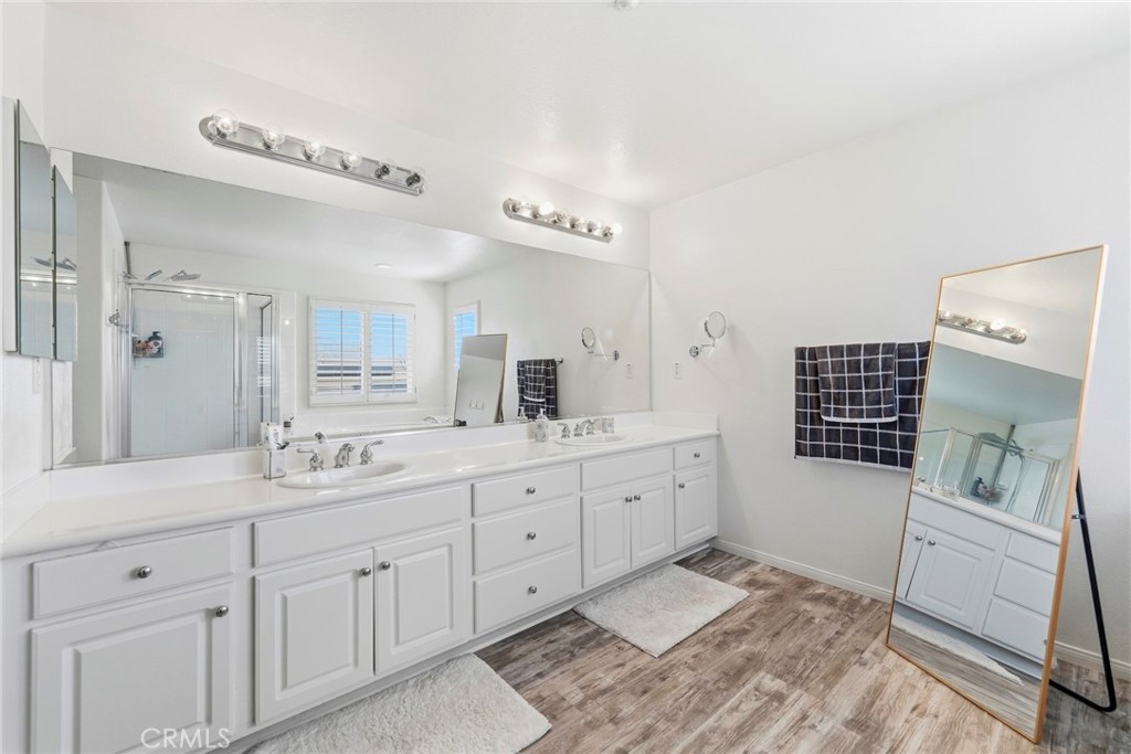 1663 Naranjo Court Redlands, CA 92374 - Photo 31 of 59 a bathroom with a double vanity sink a mirror and a shower