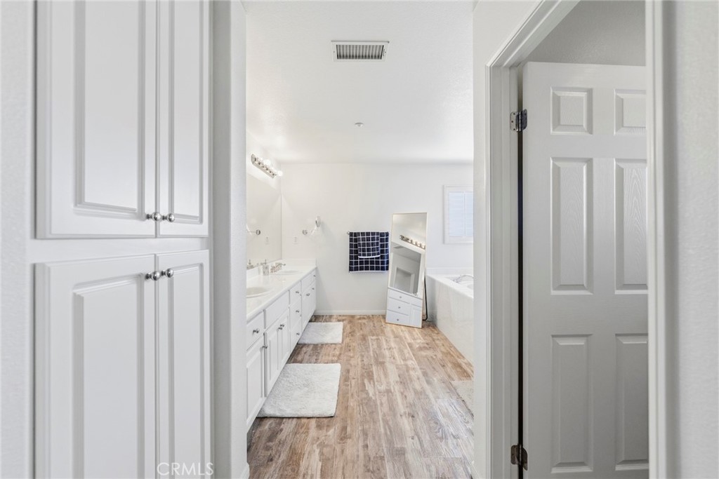 1663 Naranjo Court Redlands, CA 92374 - Photo 32 of 59 a view of a hallway with wooden floor and staircase