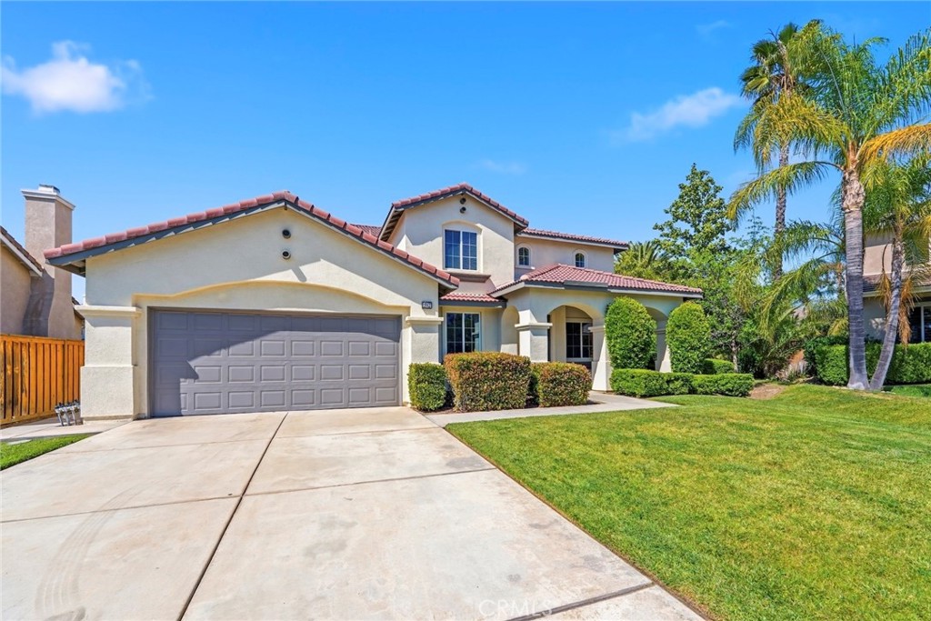 1663 Naranjo Court Redlands, CA 92374 - Photo 52 of 59 a front view of a house with a yard and garage