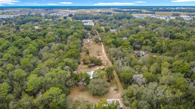an aerial view of a houses with a yard