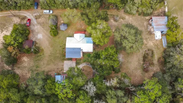 an aerial view of a houses with a yard